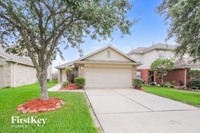 Channelview house for rent - a home with a driveway and a tree in the yard
