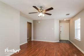 Channelview house for rent - a living room with wood flooring and a ceiling fan