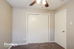 Channelview house for rent - a bedroom with two closets and a ceiling fan
