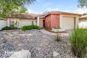 Winter Springs house for rent - a small house with a gravel driveway and a garage door