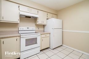 Winter Springs house for rent - a kitchen with white appliances and a refrigerator