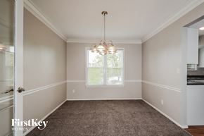 Fenton house for rent - an empty dining room with a chandelier and a window