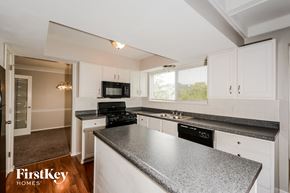 Fenton house for rent - an updated kitchen with granite counter tops and white cabinets