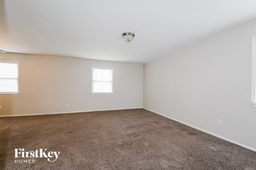 Fenton house for rent - the living room of a home with white walls and carpet