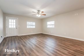 Tampa house for rent - the spacious living room with hardwood flooring and a ceiling fan