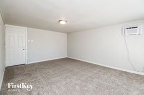 Tempe house for rent - A room with a carpeted floor and a door.