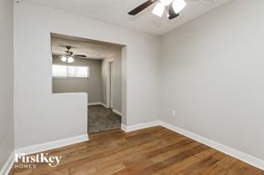 Tempe house for rent - A room with wooden floors and a ceiling fan.