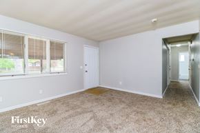 Florissant house for rent - A room with a carpeted floor and a door leading to another room.