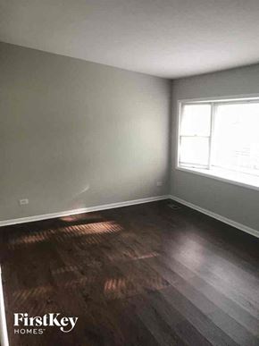 Matteson house for rent - an empty room with wooden floors and a window