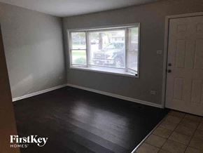 Matteson house for rent - an empty room with wooden floors and a window