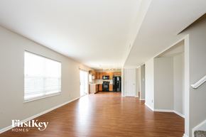 Avon house for rent - an empty living room with wood floors and a large window
