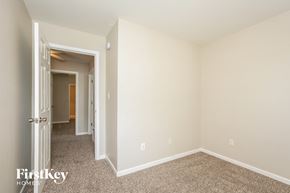 Avon house for rent - a bedroom with white walls and carpet and a door to a hallway