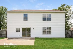 Avon house for rent - the back of a white house with a yard and grass