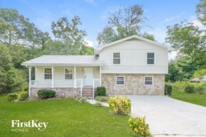 Conyers house for rent - a white house with a lawn and a white driveway