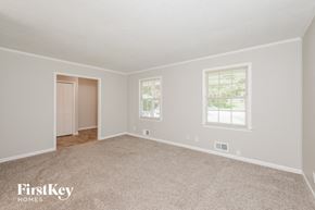 Conyers house for rent - a bedroom with carpet and two windows and a door