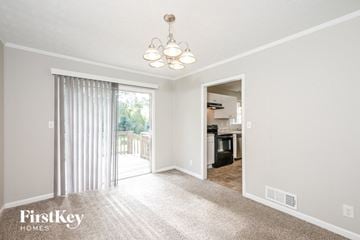 Conyers house for rent - a living room with carpet and a sliding glass door to the kitchen