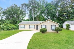 Jonesboro house for rent - a white house with a yard and a sidewalk