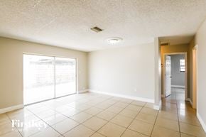 Hollywood house for rent - A spacious room with a sliding glass door leading to a balcony.
