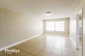 Hollywood house for rent - A spacious room with a tile floor and a window letting in natural light.