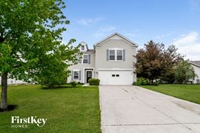 Greenfield house for rent - A house with a white garage door is for sale by FirstKey Homes.