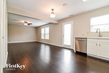 Greenfield house for rent - A kitchen with a stainless steel dishwasher and wooden floors.