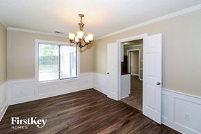Memphis house for rent - a dining room with white walls and wood flooring and a window