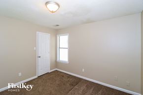 Memphis house for rent - the upstairs bedroom with carpet and a door to the bathroom