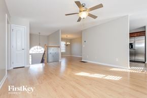 Moody house for rent - A spacious room with a ceiling fan and wooden flooring.