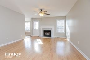 Moody house for rent - A spacious living room with a fireplace and a ceiling fan.