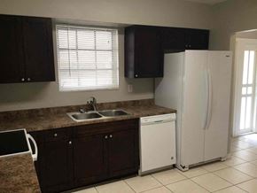 Miami Gardens house for rent - a kitchen with a sink and a refrigerator