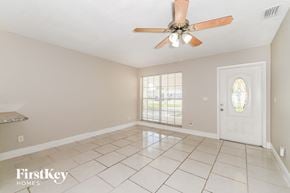 Fort Myers house for rent - A room with a fan and a door.