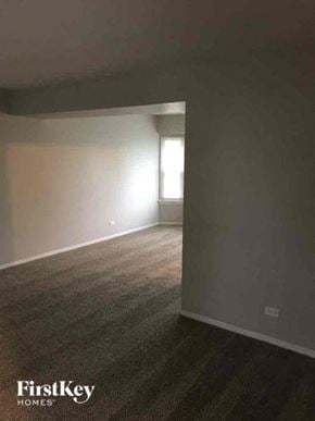 Aurora house for rent - an empty living room with a window