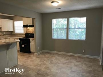 Stone Mountain house for rent - A kitchen with a black stove top oven and a tiled floor.