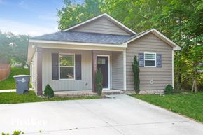 Kannapolis house for rent - A small house with a grey roof and a grey garage door.