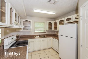 Azle house for rent - a white kitchen with white appliances and white cabinets