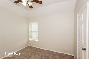 Azle house for rent - a bedroom with carpet and a ceiling fan