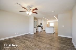 Phoenix house for rent - a living room with a ceiling fan and a kitchen