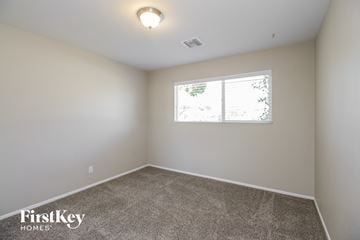 Phoenix house for rent - the spacious living room with carpet and a window