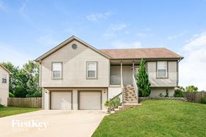 Peculiar house for rent - A two-story house with a garage and a front porch.