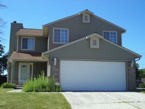 Indianapolis house for rent - a house with a garage door in front of it
