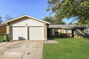 Arlington house for rent - a white garage door on a brick house with a driveway