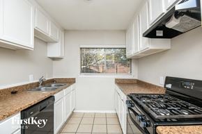 Arlington house for rent - a kitchen with a stove and sink and a window