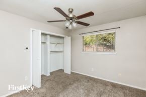 Arlington house for rent - a bedroom with a ceiling fan and a window