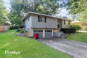 Blue Springs house for rent - a white house with a garage and a driveway