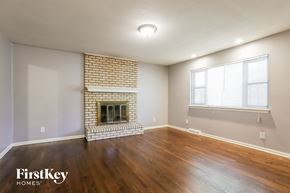 Blue Springs house for rent - the living room has a brick fireplace and hardwood floors