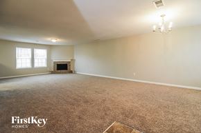 Cordova house for rent - the living room of an empty house with a fireplace