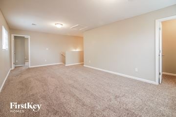 Cordova house for rent - a spacious living room with carpet and white walls