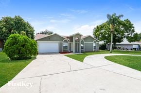 Dundee house for rent - a house with a driveway and a garage door