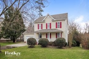 Knightdale house for rent - a white house with red shuttered windows on a green lawn