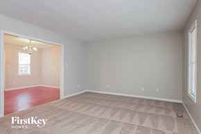 Knightdale house for rent - a living room with a carpeted floor and a door to a dining room